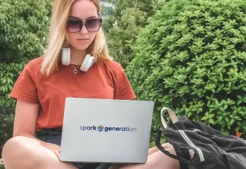 girl with laptop applying for spark generation scholarship