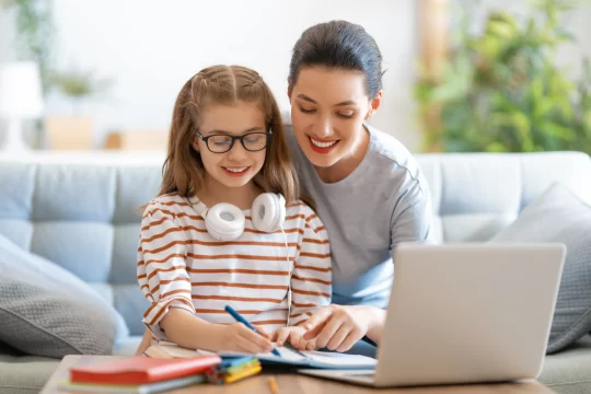 parent homeschooling their child with the help of an online education programme